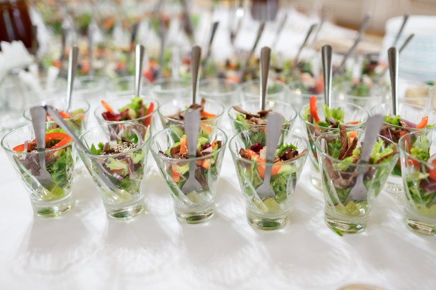 glasses-with-salad-served-on-white-table_1304-4672